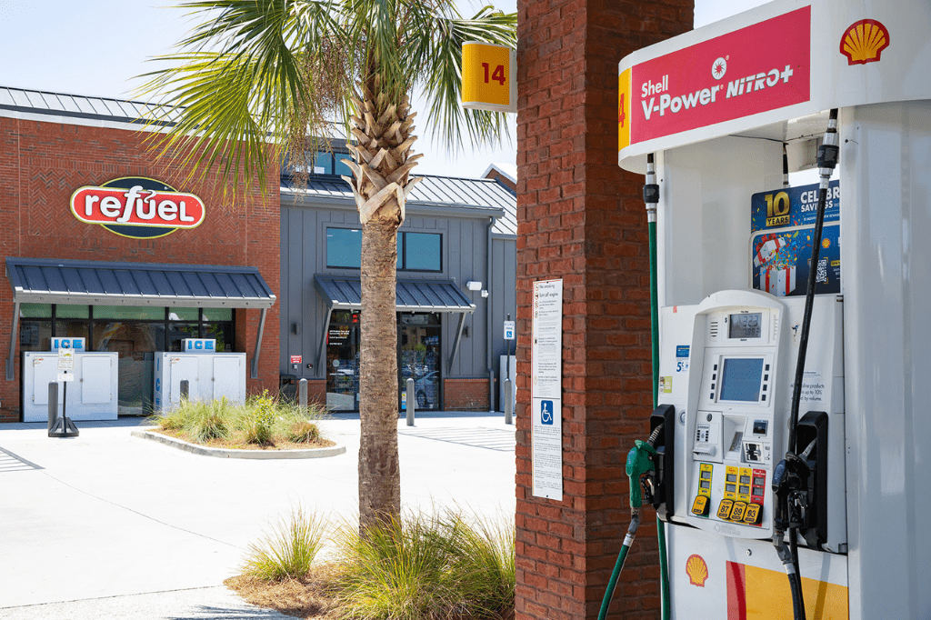 Refuel storefront with gas pump on the right hand side.