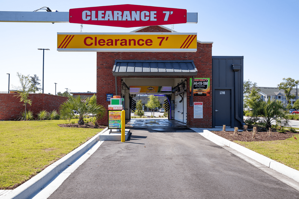 Refuel car wash center with signs above it indicating a clearance of seven feet.