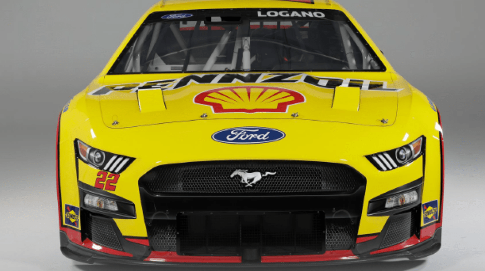 Front view of a yellow Mustang NASCAR vehicle.