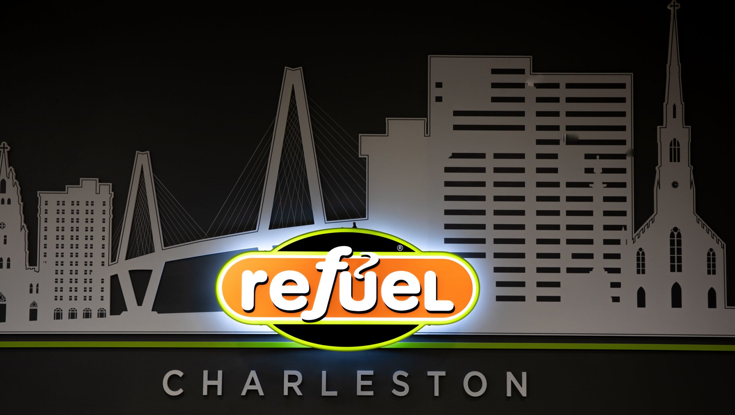Glowing Sign with Refuel Logo in front of the Ravennel bridge in Charleston, SC